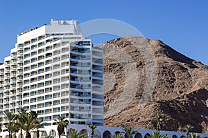 Summer time vacation season resort hotel building in the most south Israeli city Eilat near Red sea beach on sand stone desert