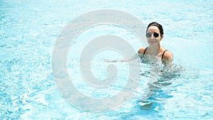 Summer time and Vacations. Women lifestyle with fashion relaxing and happy in luxury swimming pool outdoor,