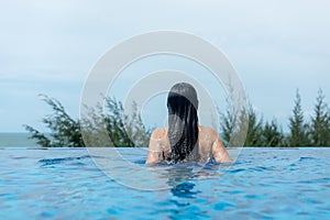 Summer time and Vacations. Women lifestyle relaxing and happy in luxury swimming pool sunbath, summer day at the beach resort in t