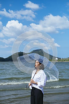 Summer time with young asian woman holding umbrella