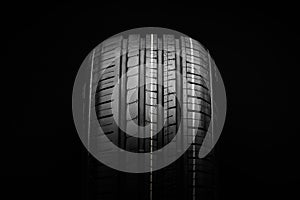 Summer tire. Profile of a summer tire on a black background close-up