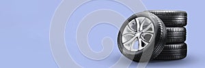 summer tires and wheels-stack on blue background, new wheels long blank layout copyspace