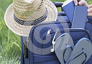 Summer, tourism. Blue suitcase collected for travel.