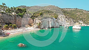 Summer touristic destination in Puglia, Italy: Faraglioni di Puglia Baia delle Zagare - Beach and faraglioni rocks formation