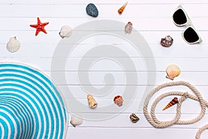 Summer travaling to the sea with straw hat, sun glasses, shells on white wooden background top view mock up