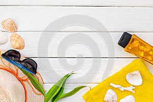 Summer travaling to the sea with straw hat, sun glasses, sunblock lotion on white wooden background top view mock up