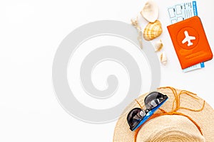 Summer travaling to the sea with straw hat, sun glasses, tickets and passport on white background top view mock up