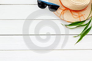 Summer travaling to the sea with straw hat, sun glasses on white wooden background top view mock up