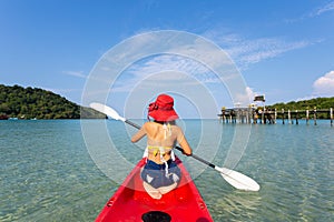 Summer travel Back view of young woman on the beach at Sea