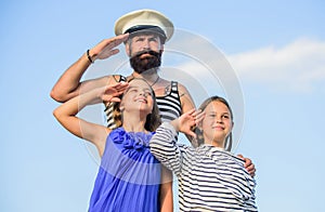 Summer travel concept. Happy family. Dad sailor and daughters outdoors. Captain welcome on board. Marine tour. Sea
