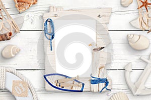 Summer travel photo family isolated frame for mockup surrounded with shells on white wooden table