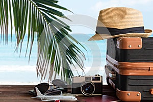 Summer travel and plan with vintage suitcase luggage and old camera in the sand beach. Travel in the holiday trips, airplane. blu photo