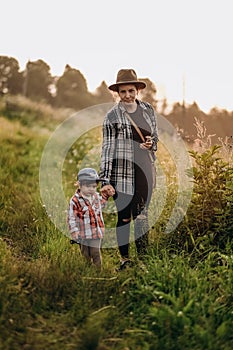 Summer trip with children to the mountains. Evening walk of a mother with a child in an alpine village in summer.