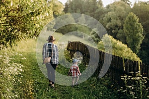 Summer trip with children to the mountains. Evening walk of a mother with a child in an alpine village in summer.