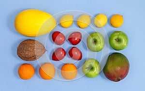 Summer tropic fruits layout on pastel bright blue background. Flat lay exoti arrangement