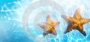 Summer tropical beach background; starfish, sand and blue water