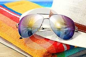 Summer tropical beach background with sunglasses and hat