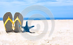 The Summer Tropical beach with starfish and flip flop  as  white sand beach scene and blue sky  background-copy space