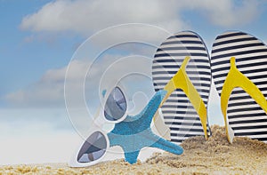 The Summer Tropical beach with starfish and flip flop-sunglasses as  sand beach scene and blue sky  background