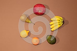 Summer tropical compositin made with fresh fruit on brown background. photo