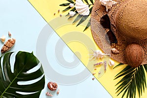 Summer, tropical f turquoise and yellow background with a straw hat, coconut, sunglasses