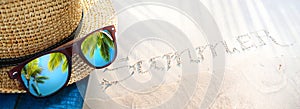 summer tropical holiday, tropic holidays banner. sand beach from above with straw bucket hat and sunglasses, palm trees reflection