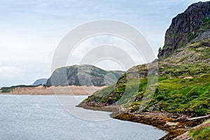 Summer tundra. Rocky coastline of Barents Sea near Teriberka. Scenery of Russian North. Kola Peninsula, Murmansk Oblast,