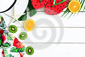 Summer vacation background of fruits, flip flops and hat