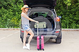 Summer vacation car road trip freedom concept. Happy woman cheering joyful during holiday travel with car.