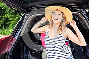 Summer vacation car road trip freedom concept. Happy woman cheering joyful during holiday travel with car.