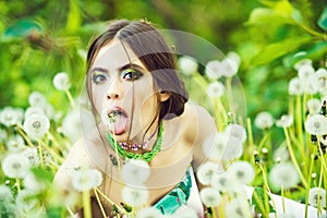 Summer vacation concept. Beauty fashion portrait. young woman with fashionable makeup and beads in green leaves