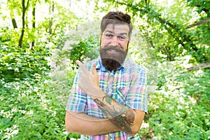 Summer vacation concept. Explore wild nature activity. Man bearded hipster green trees background. Emotional nature