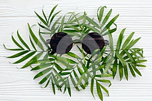 Summer vacation concept, flat lay. stylish black sunglasses on g