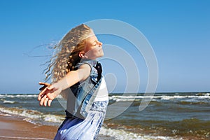 Summer vacation concept.Happy child against blue sky background