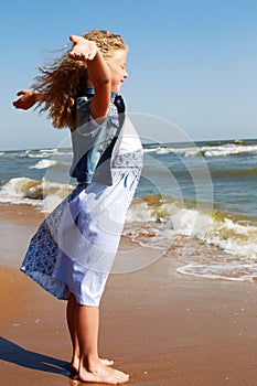 Summer vacation concept.Happy child against blue sky background
