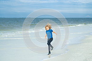 Summer vacation concept. Happy little kid running on the beach, walking on sea sandy beach. Travel adventure kids