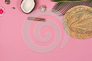 Summer vacation concept. stylish hat and green palm leaves on pink background, flat lay