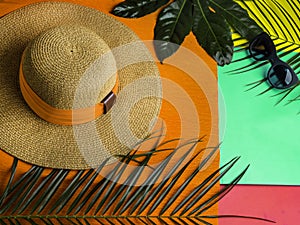 Summer and Vacation concept. Tropical Summer Background. Palm Trees Branches, hat, sunglasses. Travel and spa