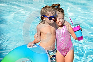 Summer vacation. Couple of kids rest in swimming pool.