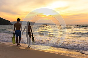 Summer Vacation. Couple walking holding hands on tropical on the beach sunset time in holiday after snorkel swim. Honeymoon holid