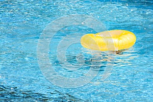 Summer vacation, flotation device and safety equipment for swimming concept with a lifesaver or life ring floating in a blue empty