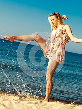 Summer vacation. Girl having fun on the sea coast