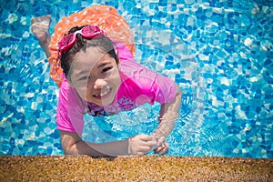 Happiness and Smiling Asian cute little girl has feeling funny and enjoy in swimming pool.