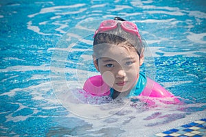 Happiness and Smiling Asian cute little girl has feeling funny and enjoy in swimming pool.