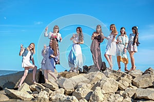 Summer vacation, holidays, travel and people concept - group of smiling young women on beach