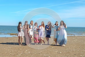 Summer vacation, holidays, travel and people concept - group of smiling young women on beach