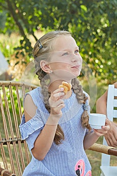 Summer vacation - little girl having tea