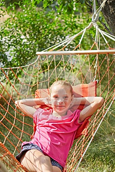 Summer vacation - lovely girl in wicker hammock