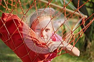 Summer vacation - lovely girl in wicker hammock