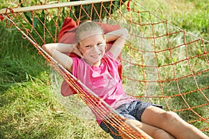 Summer vacation - lovely girl in wicker hammock